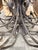Stunning, oversized vintage-style wrought iron chandelier. This massive statement piece features and elegant cage-top...