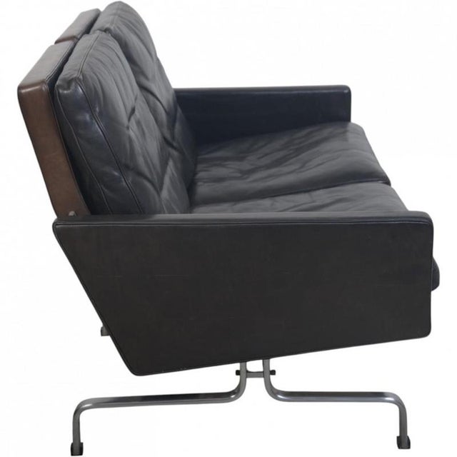 Poul Kjærholm PK31/2 sofa upholstered in original black elegance leather, and with a frame of chromed spring steel. The...