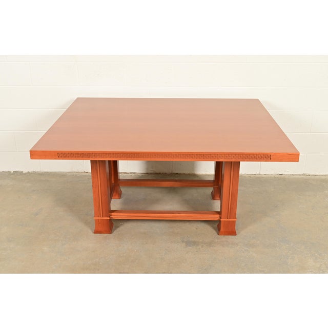 An exceptional Arts & Crafts or Prairie style carved cherry wood dining table By Frank Lloyd Wright for Cassina Italy,...