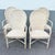 Elegant boho chic dining arm chairs crafted in pencil reed and rattan, featuring softly arched backs with a subtle wave...