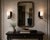 Sculptural pair of wall sconces designed and manufactured in Los Angeles by Paul Marra, executed in ebonized wood, brass...