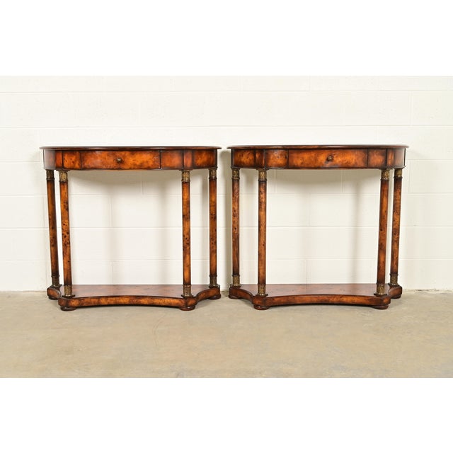 A gorgeous pair of French Empire or Neoclassical style demilune console tables In the manner of Maitland Smith USA, Circa...
