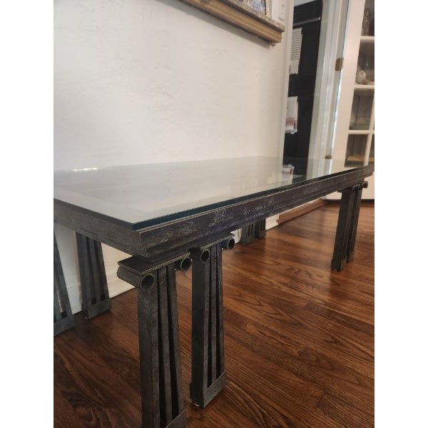 Postmodern lacquered wrought iron coffee table with ionic column table legs and inner step detail under glass top. Slight...