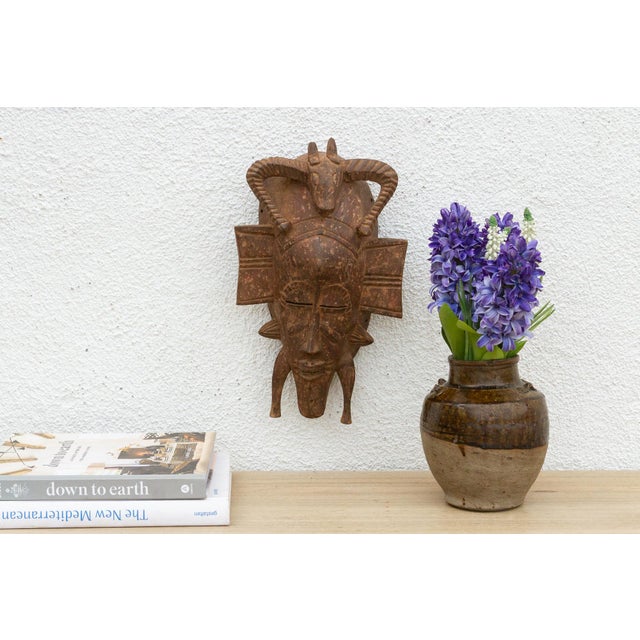 This striking mask, with its bold geometric patterns and avian-inspired design, speaks of a rich cultural heritage and...