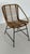 Woven rattan lounge chair, Italian design. Fits perfectly into a minimalist 1960s lounge setting. Matte black metal base....