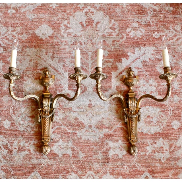 A very finely cast pair of two light French Neoclassical bronze sconces. Lovely French Louis XVI details abound: precisely...
