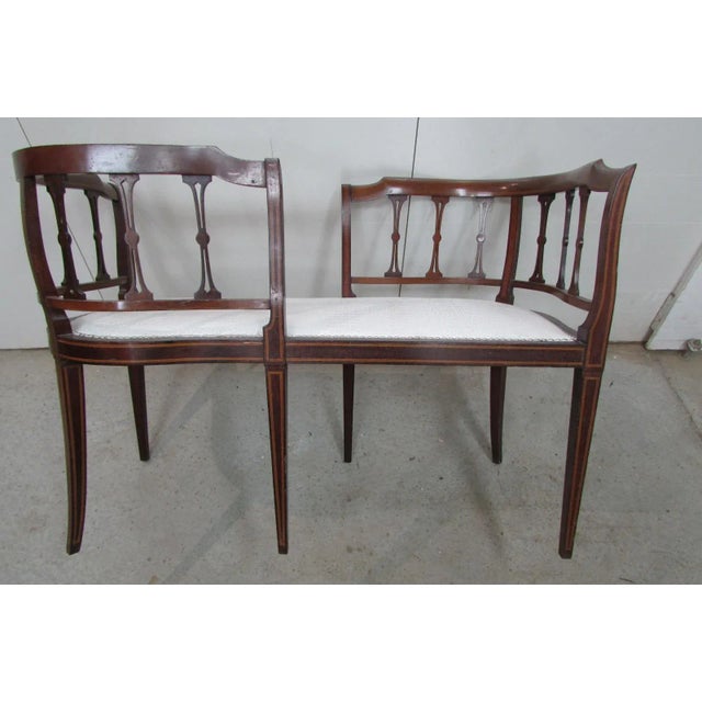 Tandem seat, made of solid mahogany, featuring lemonwood edging with walnut veneer inlay, with stylized bars throughout...