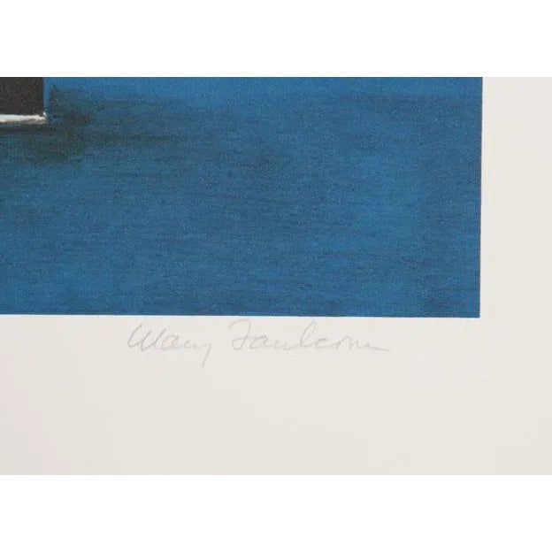 Set on a royal blue table or tablecloth, the flower arrangement held within a red-and-black cannister is full of different...