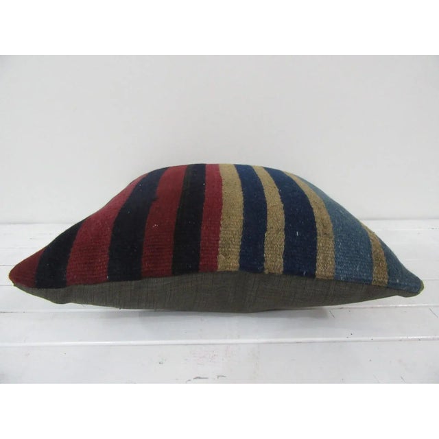 This is a pillow cover made from a vintage kilim rug. The piece was properly washed and ready to use. Pillow inserts not...