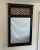 Very cool Hollywood Regency style mirror. It's classic black with open gold colored scrollwork on the top. Manufactured in...