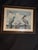 Large framed coastal wildlife art print featuring brown pelicans, a gull, and other shorebirds perched on wooden pilings....