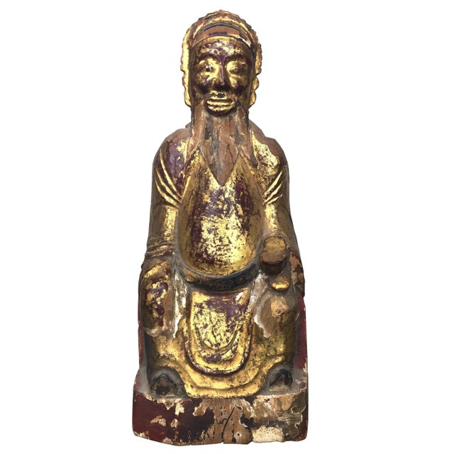 A trip of Chinese ancestor figures. Carved, painted and gilded, these pieces were used in the veneration and worship of...