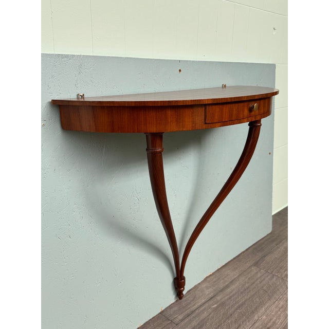 A half-moon wall console, a refined piece of Italian design from the 1950s inspired by the style of architect and designer...