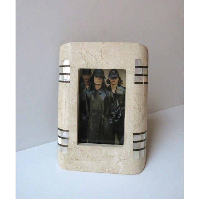 A neutral tan marble picture frame with brass and mother of pearl accents, in the Modern style or Postmodern period, circa...