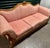 This is a vintage, French Provincial-style 3 seater sofa characterized by its ornate carved wooden frame, sweeping curves,...
