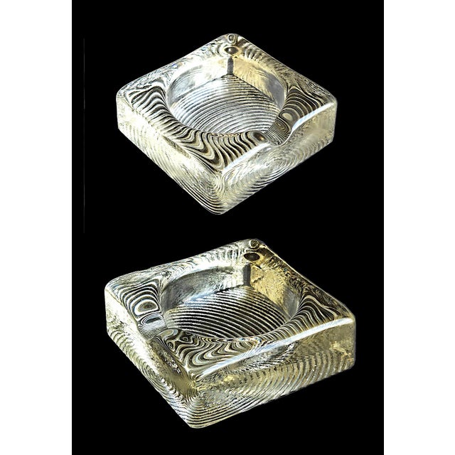 Offered is a mid 20th Century, circa. 1970s, transparent molded glass cigar ashtray with an off-center metropolitan...