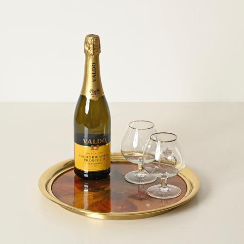 Stunning and highly decorative Mid-Century round serving tray crafted from polished gilt brass, lucite, and real dried...