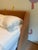 The Nook Queen Bed by Blu Dot features a distinctive wraparound headboard that curves gently into the upholstered frame,...