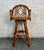 This is a rattan barstool with a palm tree upholstered cushion. With a rounded back and a solid rattan frame this...