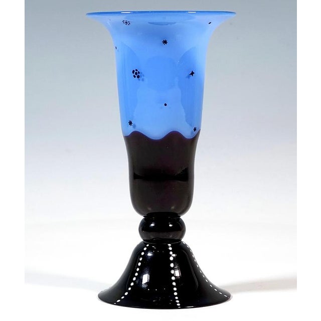 Model-blown body, trumpet-shaped with flared rim, constriction in the lower section, melted nodus and outwardly curved...