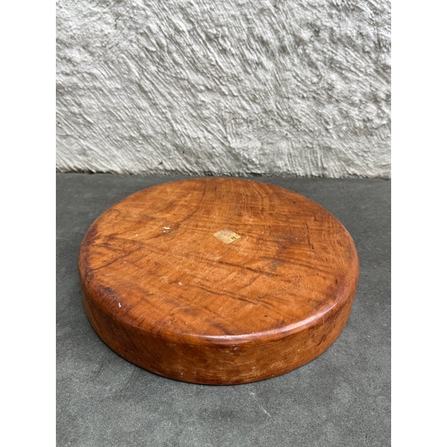 Round turn wood teak tray. Made from a single piece of wood. The remnants of the original paper label is located on the...