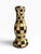Striking vintage black and gold candlestick featuring a bold hand-painted checkerboard pattern over a turned, classical...