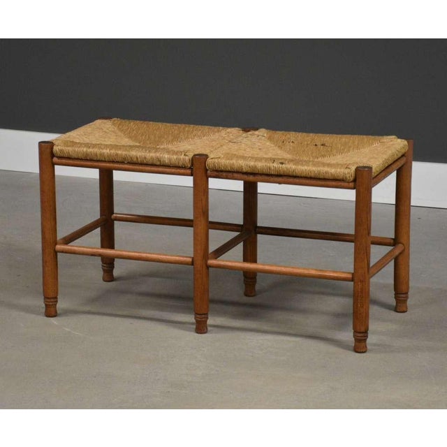 A Danish country modern seagrass two seater bench with oak legs. Made in Denmark. Circa 1970’s. 34.25” wide. 15.75” deep....