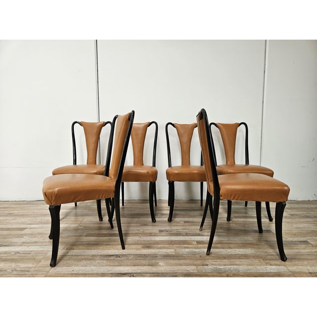 A refined set of six Italian chairs from the 1950s, attributed to Vittorio Dassi, featuring an elegant, sculptural line...