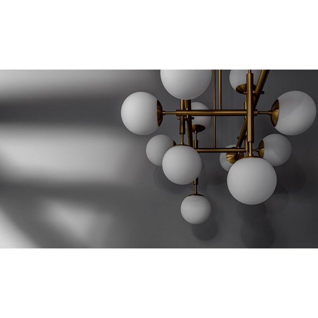 A playful pattern of organized segments tells a story of sophisticated spheres enlivened with brass lines. The enchanting...