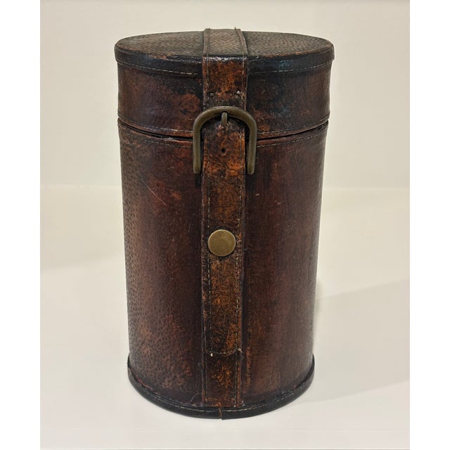 Handsome leather covered cylindrical case believed to have originally housed a single liquor bottle or spirits decanter....