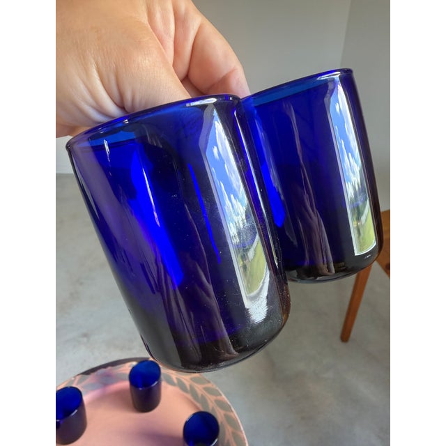 Striking set of seven cobalt blue lowball glasses in a sophisticated Art Deco-inspired form. Hand-blown and beautifully...