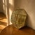 A vintage geometric wall light from the 1980s, featuring a faceted brass frame and clear glass panels. The multi-sided...