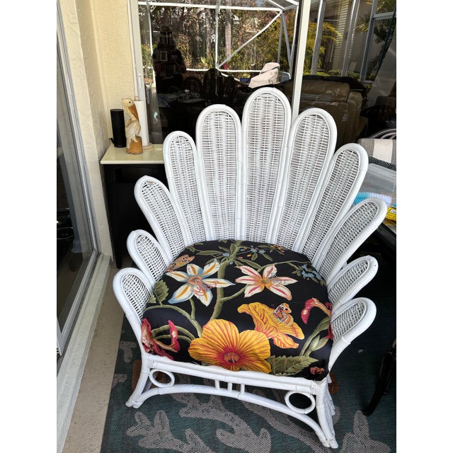 Popular vintage palm frond white rattan and wicker lounge chair. Upholstered in stunning contrasting botanical upholstery....