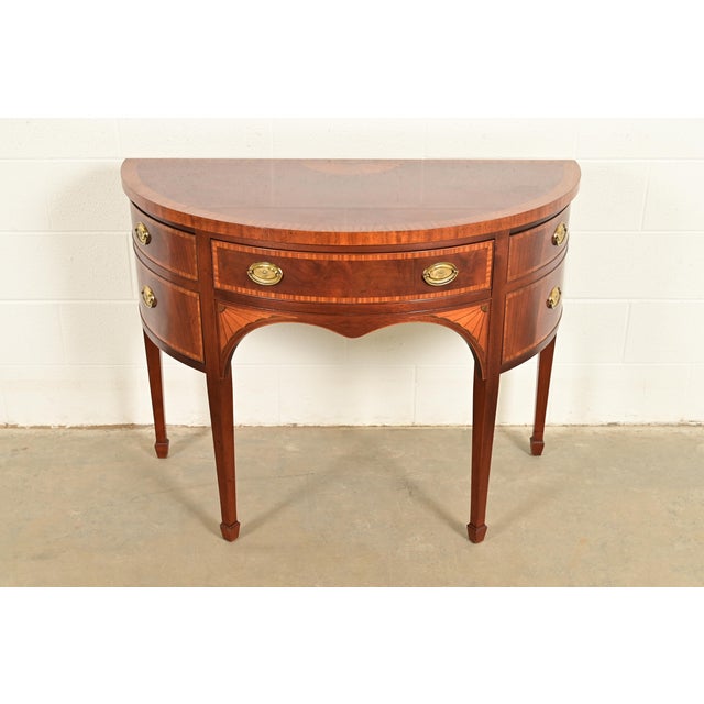 An exceptional Federal or Hepplewhite style demilune cabinet or sideboard By Baker Furniture USA, Circa 1980s Mahogany,...