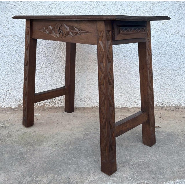 This side or coffee table exhibits characteristics of a rustic style of European origin, with influences that could point...