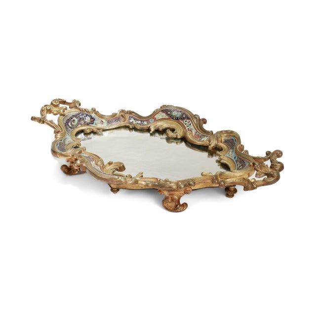 A fine, large antique French mirrored plateau or centerpiece. In gilt bronze. With twin handles, a shaped rocaille border,...