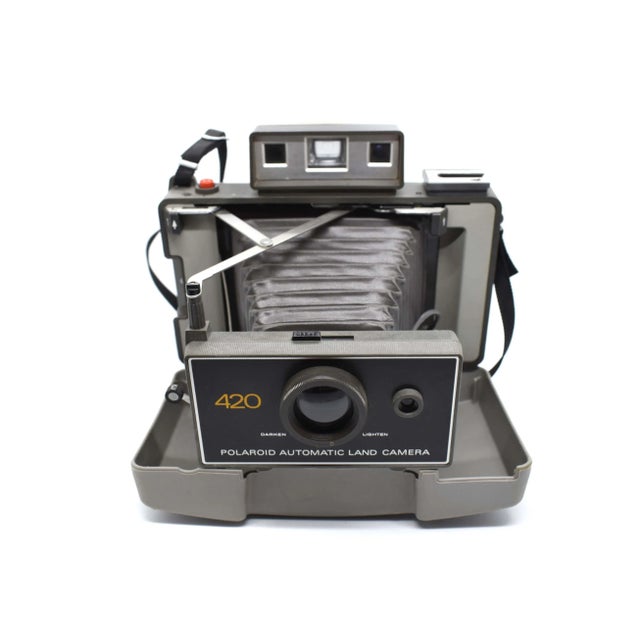 The Polaroid Automatic Land Model 420 camera with cover. It will enhance any décor, any office, media room, library or...
