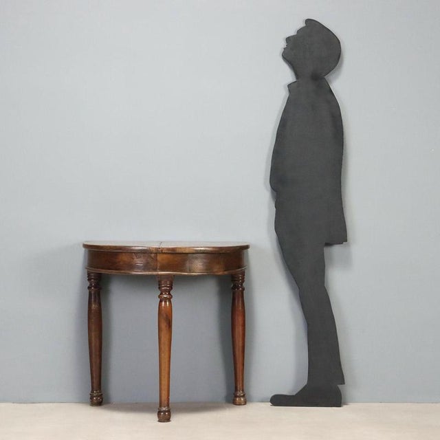 Mid-19th century demi lune console, crafted in Italy, featuring an elegant and functional design. The structure is...