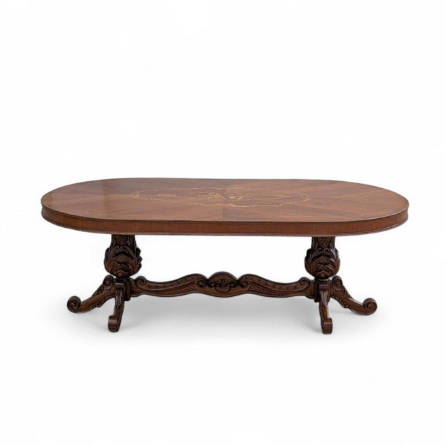 An impressive antique Renaissance Revival dining table with an oval walnut-veneered top, radiating sunburst pattern and...