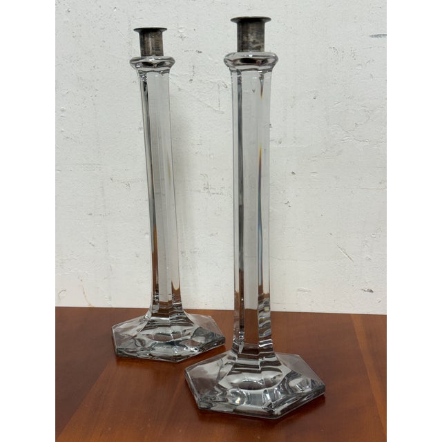 Design Plus Gallery presents a Pair of Vintage Glass Candlesticks from unknown brand. The candlestick frames are elongated...