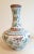 Chinese Porcelain butterfly changjingping, a long necked vase with a gold glazed lip, and a white glazed exterior,...