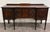 This is a gorgeous and elegant antique Edwardian Sheraton Revival or Federal sideboard crafted in richly figured flame...