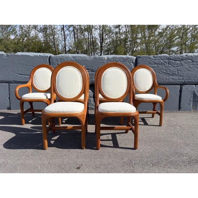 Set of Six Pencil Reed Dining Chairs, two arm and four side chairs. Arm chairs are 22.75" wide and arm height is 25"...