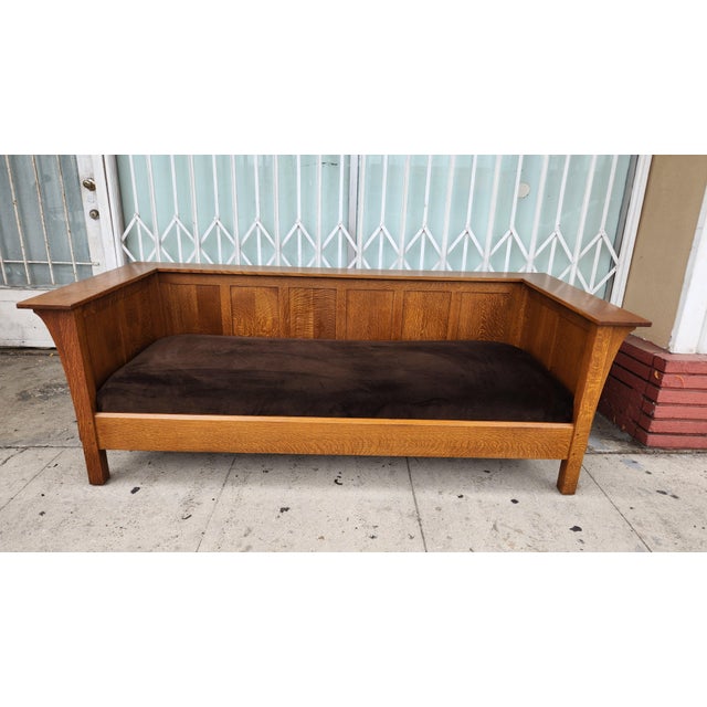 Authentic Stickley Mission style sofa is crafted from quarter-sawn oak with a warm honey finish. This piece has dark brown...