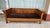 Authentic Stickley Mission style sofa is crafted from quarter-sawn oak with a warm honey finish. This piece has dark brown...