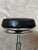 Authentic workshop stool dating from the 1920s, featuring an elegant metal frame and an upholstered seat covered in black...