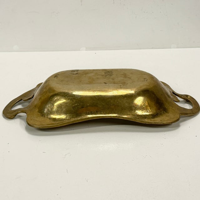 A beautiful and heavy solid brass tray (1.7 kg) from the 1930s–40s. It features a lovely natural patina developed over...