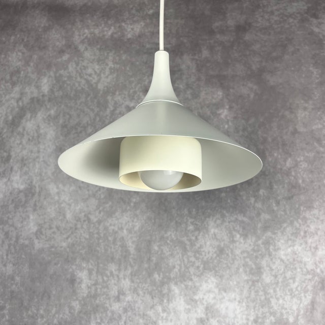Vintage white conical ceiling lamp Denmark, 1980s with its distinctive layered Scandinavian design, it offers a unique...