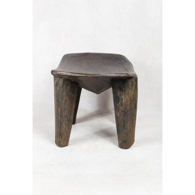 Elevate your living space with the authentic charm of the Senufo Stool, a masterpiece of African craftsmanship. Hand-...