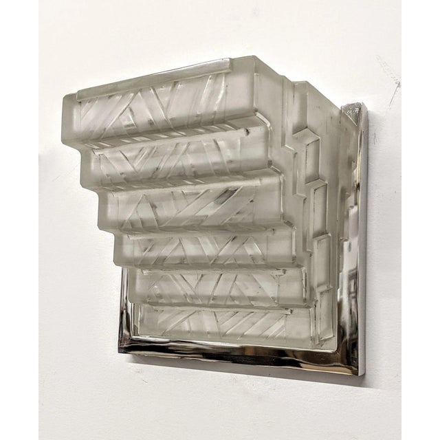 A stunning pair of French Art Deco wall sconces by the French master “Marius Ernest Sabino“. Square shaped shades in clear...